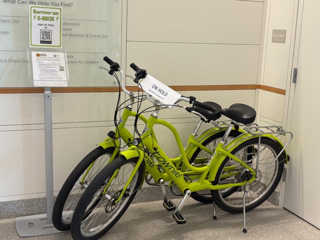 a photo of two bright green e-bikes parked next to each other inside a building