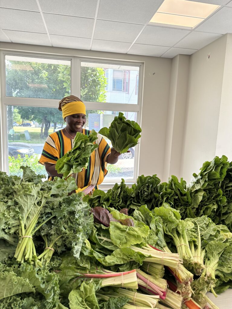 a woman sorting trays of green produce