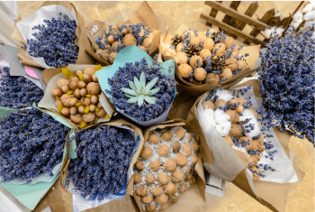 a group of bouqets of purple and beige dried flowers